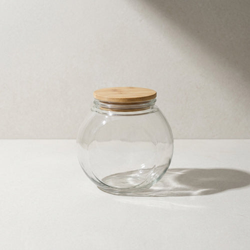Kensington London glass storage jar with airtight bamboo lid on pale limestone