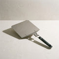Kensington London folding stainless steel pizza peel on pale limestone