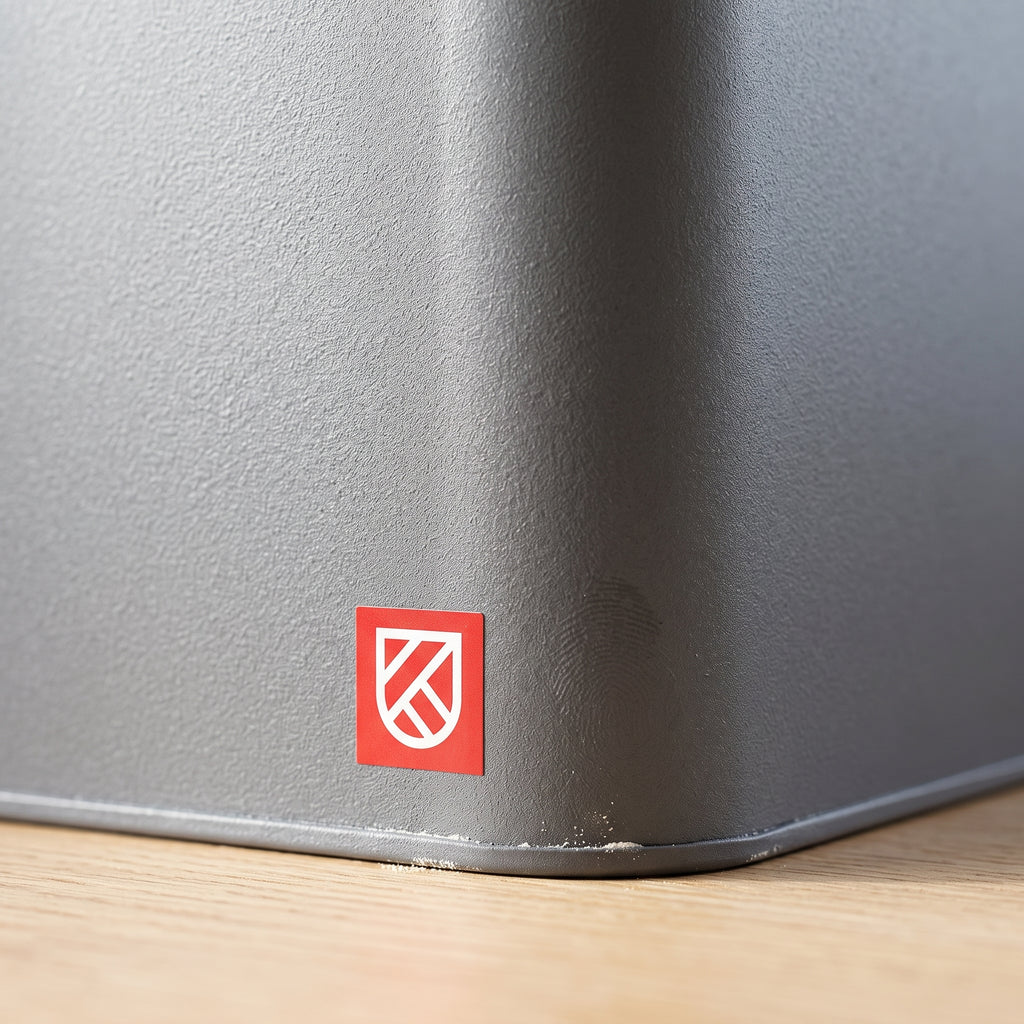 Macro of the powder-coated flank and the brand badge on the bread box